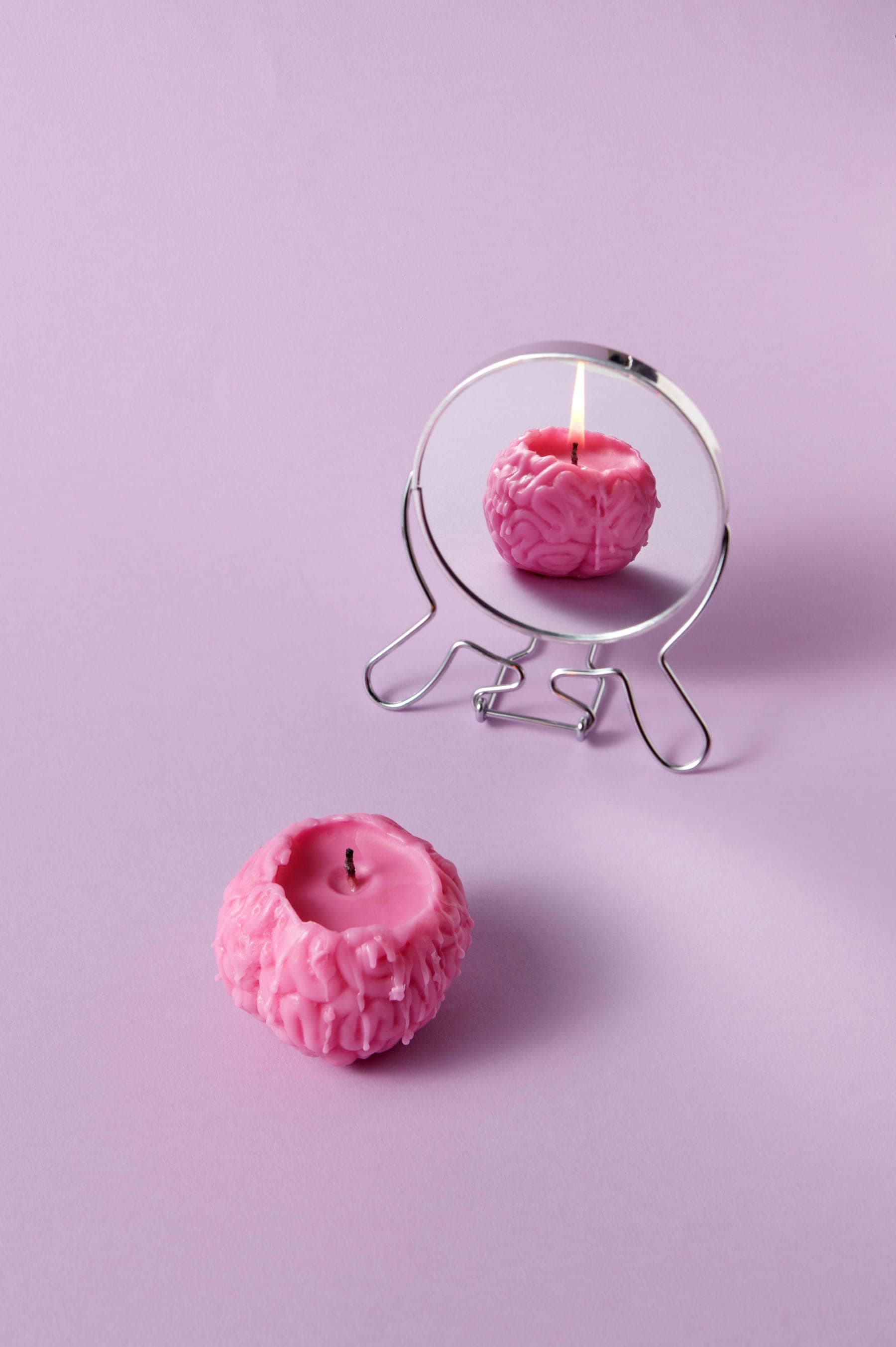 A pink brain as a candle — the spark of potential waiting to be ignited